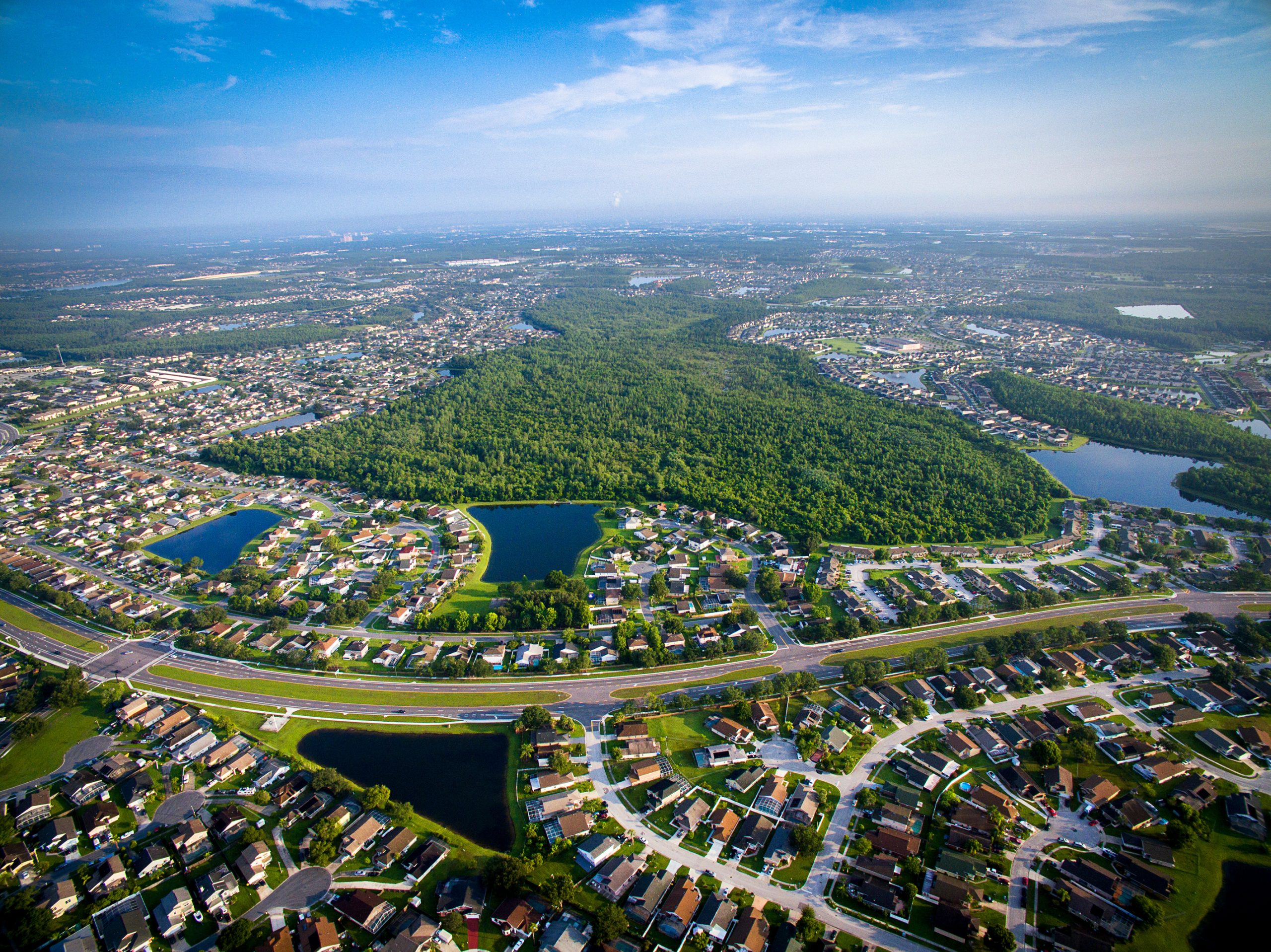 Aerial view of a suburban cityscape with highways.