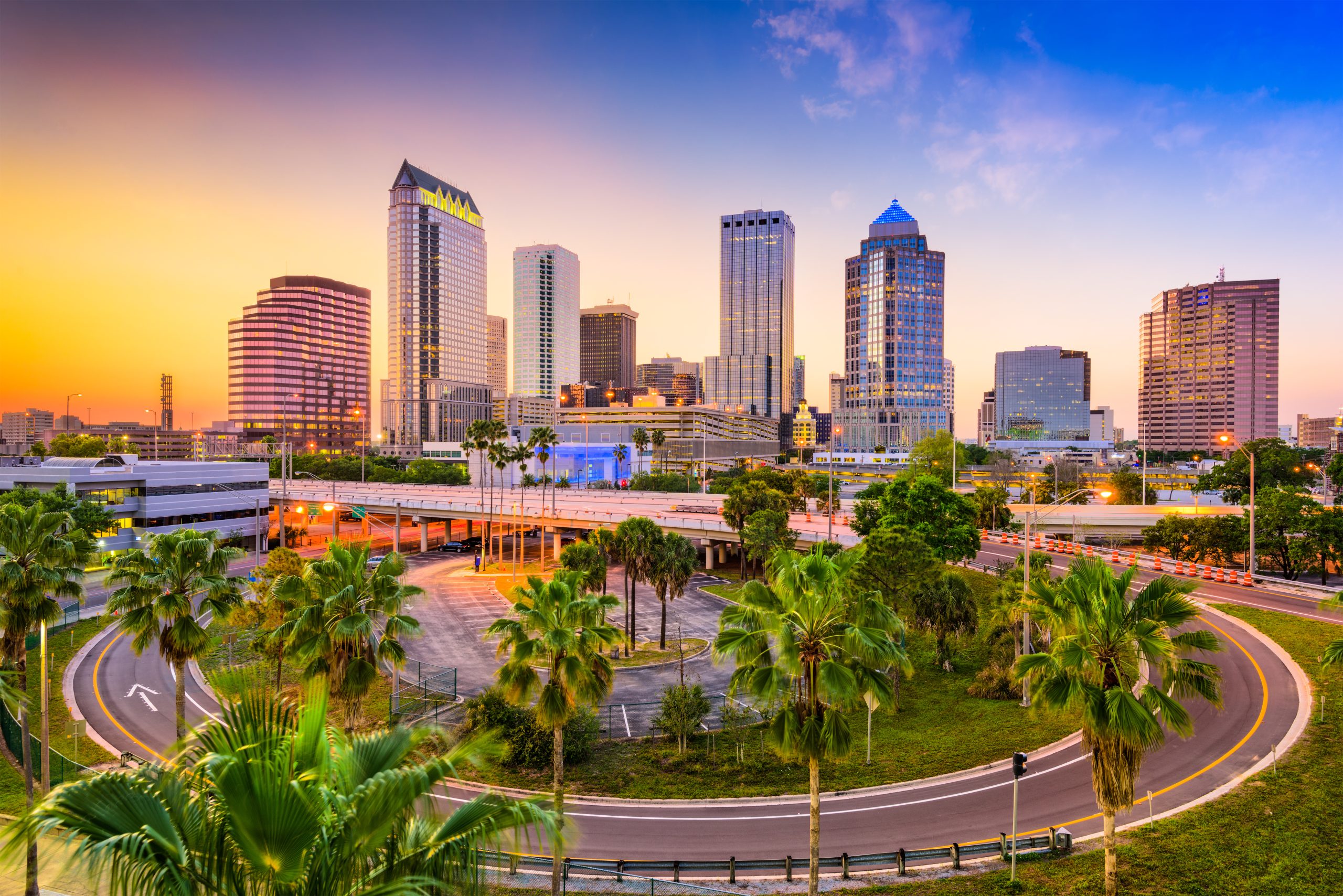 Downtown skyline of a major city at dusk.