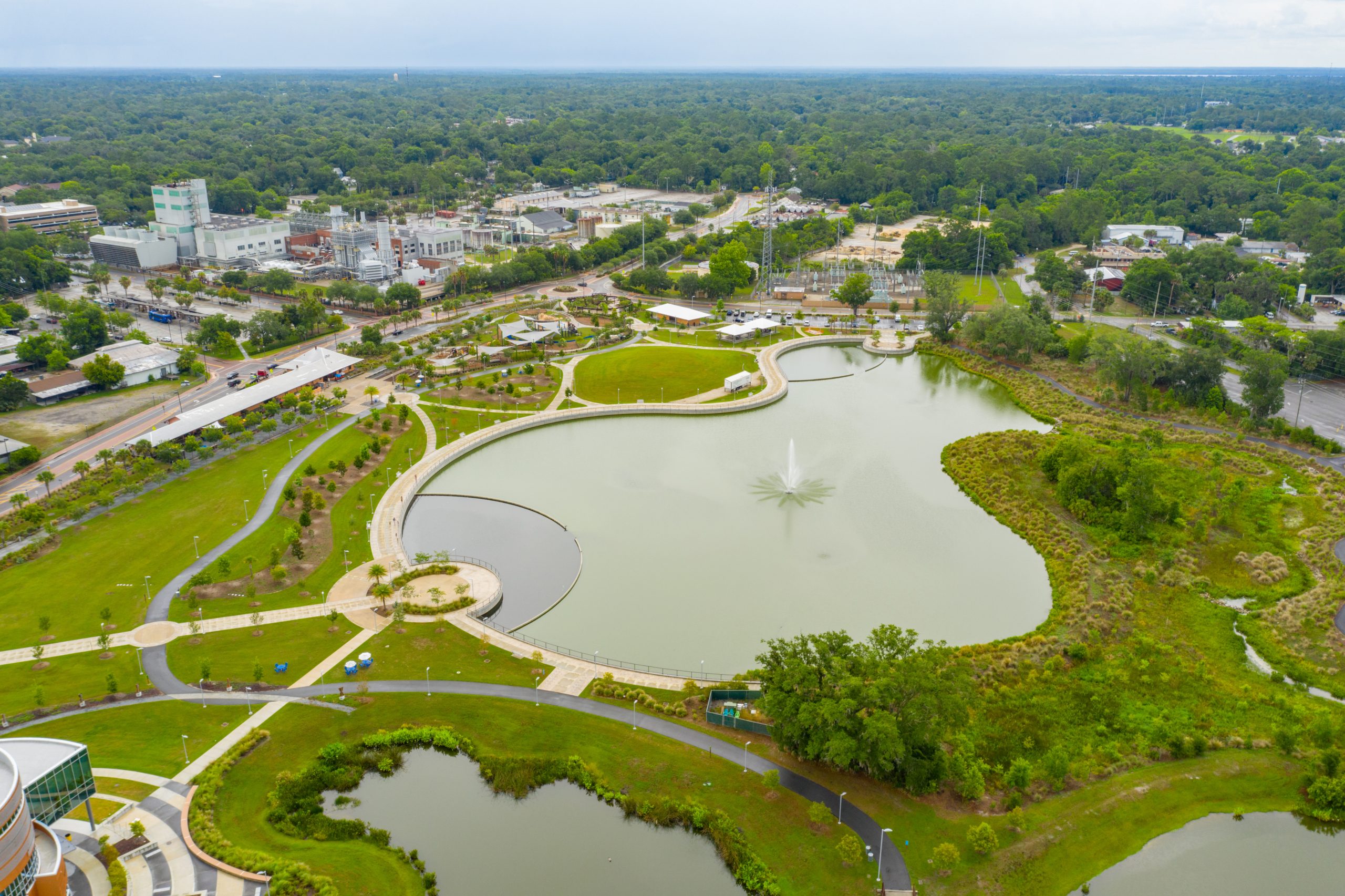 Aerial shot of a winding river surrounded by lush greenery